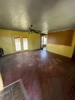 a view of a yard with wooden fence