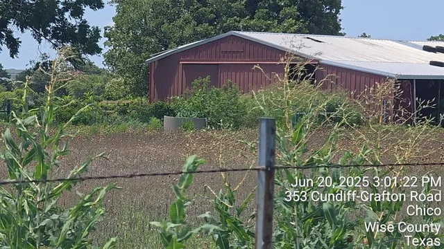 a aerial view of a house with a yard and potted plants