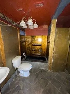 a bathroom with a toilet and a shower