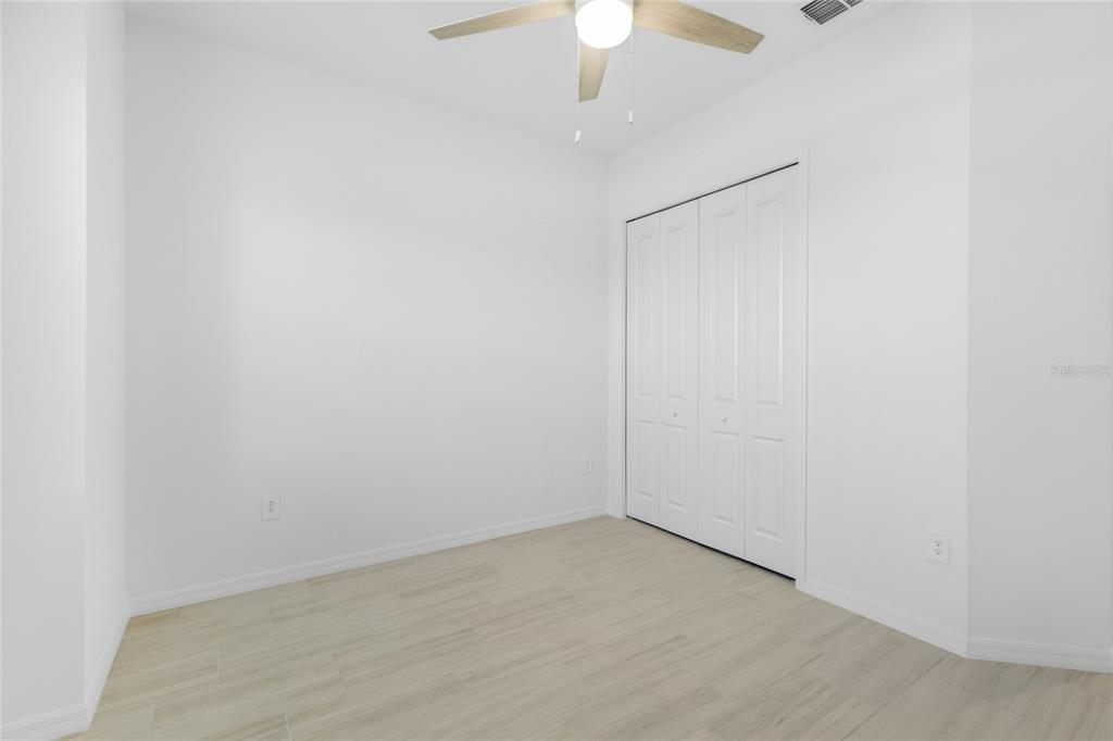 19156 Cherrystone Way Lakewood Ranch, FL 34211 - Photo 24 of 49 an empty room with a ceiling fan and a window