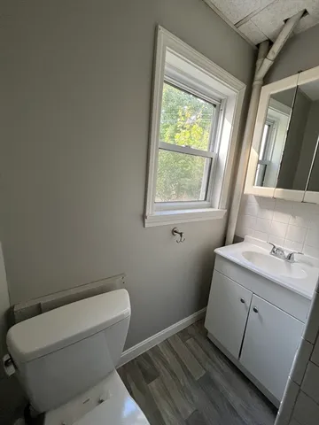 a bath room with a toilet and a bath tub