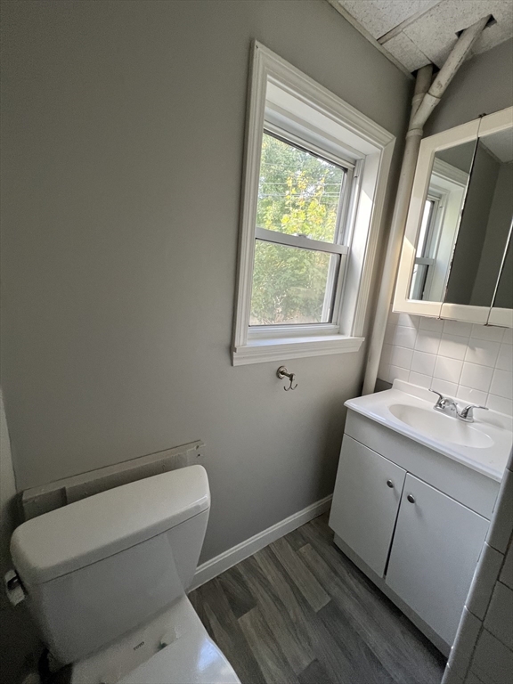 696 Broadway, Unit 1 Chelsea, MA 02150 - Photo 11 of 12 a bathroom with a toilet sink and window