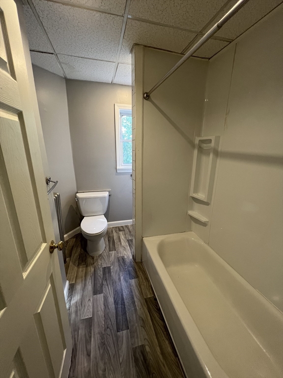 696 Broadway, Unit 1 Chelsea, MA 02150 - Photo 12 of 12 a bath room with a toilet and a bath tub