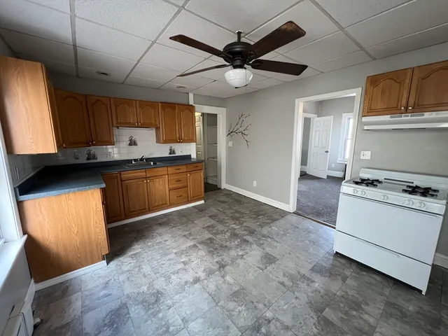 a kitchen with stainless steel appliances granite countertop a stove sink and cabinets