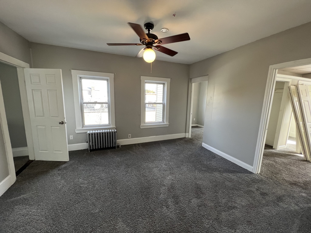 696 Broadway, Unit 1 Chelsea, MA 02150 - Photo 5 of 12 a view of a livingroom with a ceiling fan and window