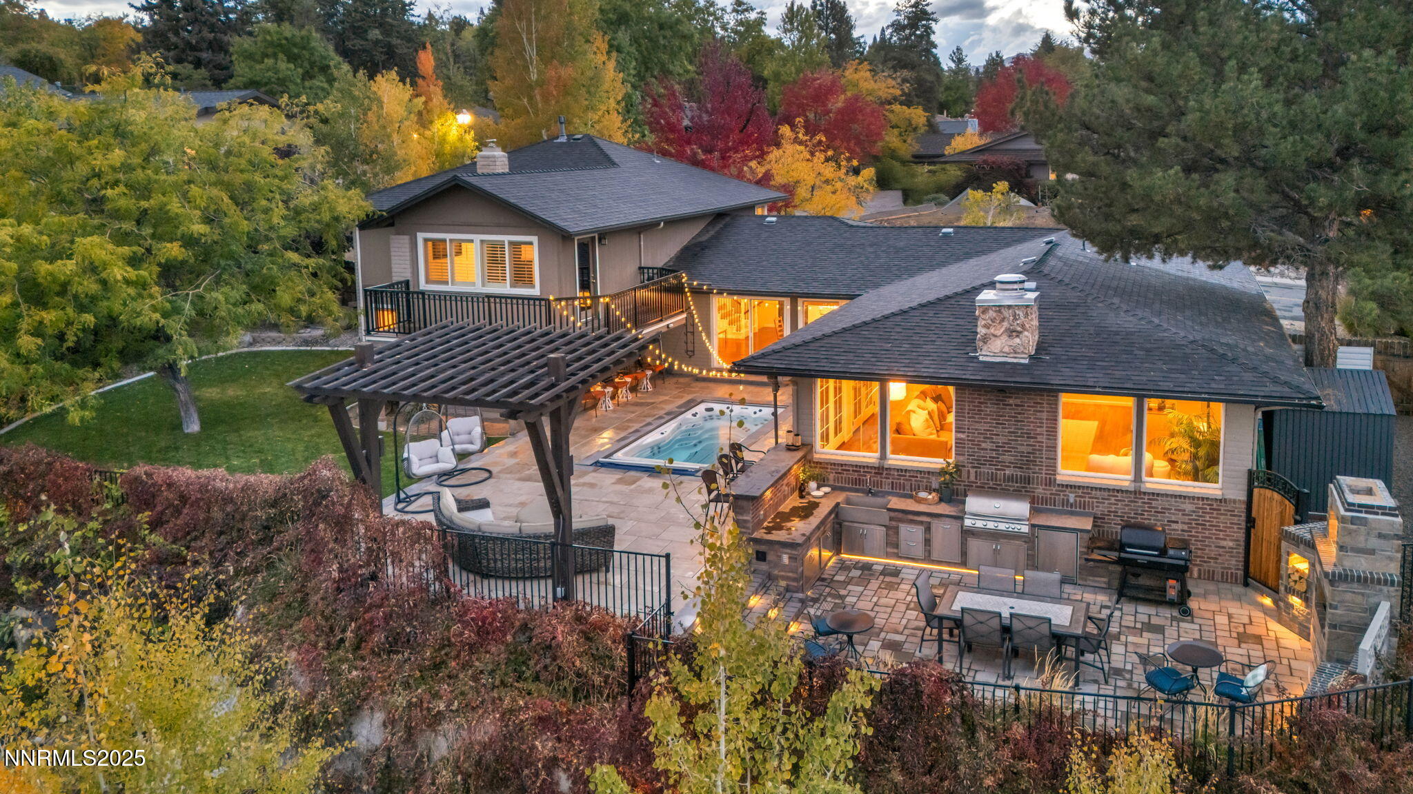 an aerial view of a house with a yard table and chairs