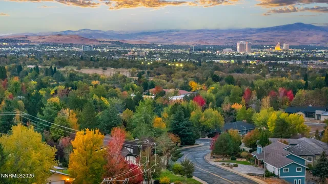 a kitchen with stainless steel appliances granite countertop a stove top oven a refrigerator and wooden floor
