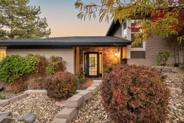 a living room with a large window and a floor to ceiling window