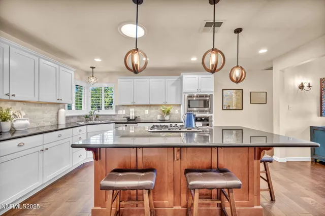 a living room with fireplace furniture and a wooden floor