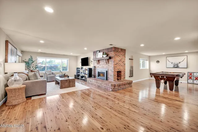 a view of a workspace with furniture and wooden floor