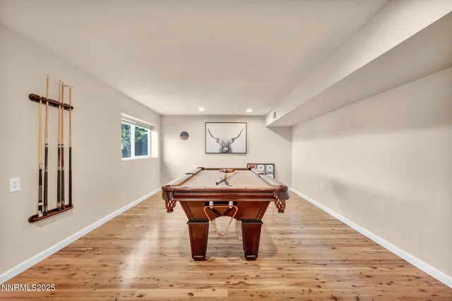 a bedroom with a large bed and a wooden floor