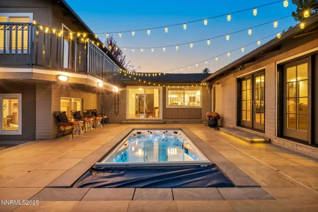 a room with pool table and large windows