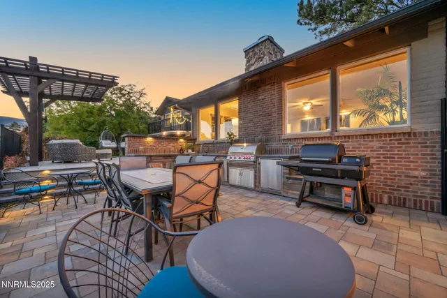 a living room with stainless steel appliances furniture and a kitchen view