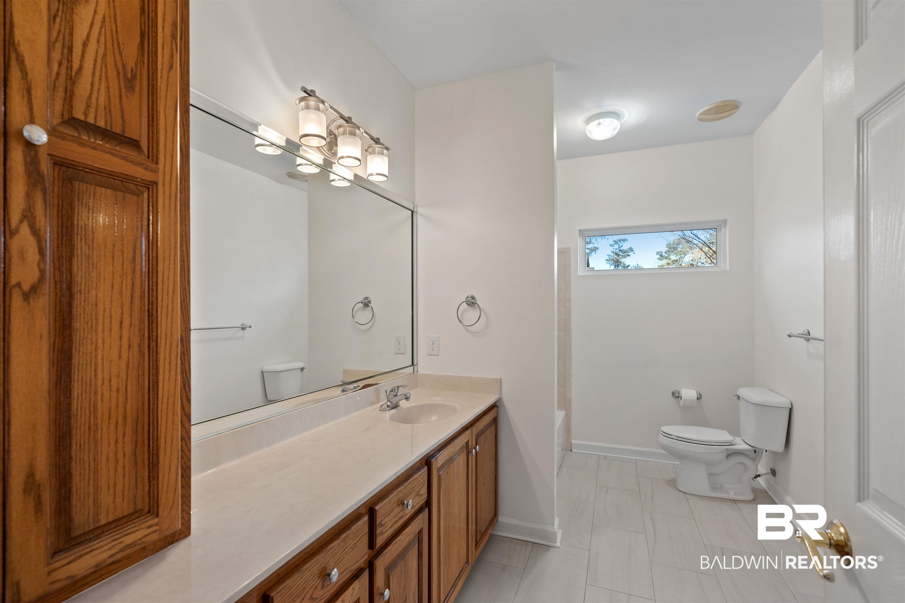 4 Judd Trail Daphne, AL 36527 - Photo 31 of 45 Full bath with vanity, an inviting chandelier, toilet, and baseboards