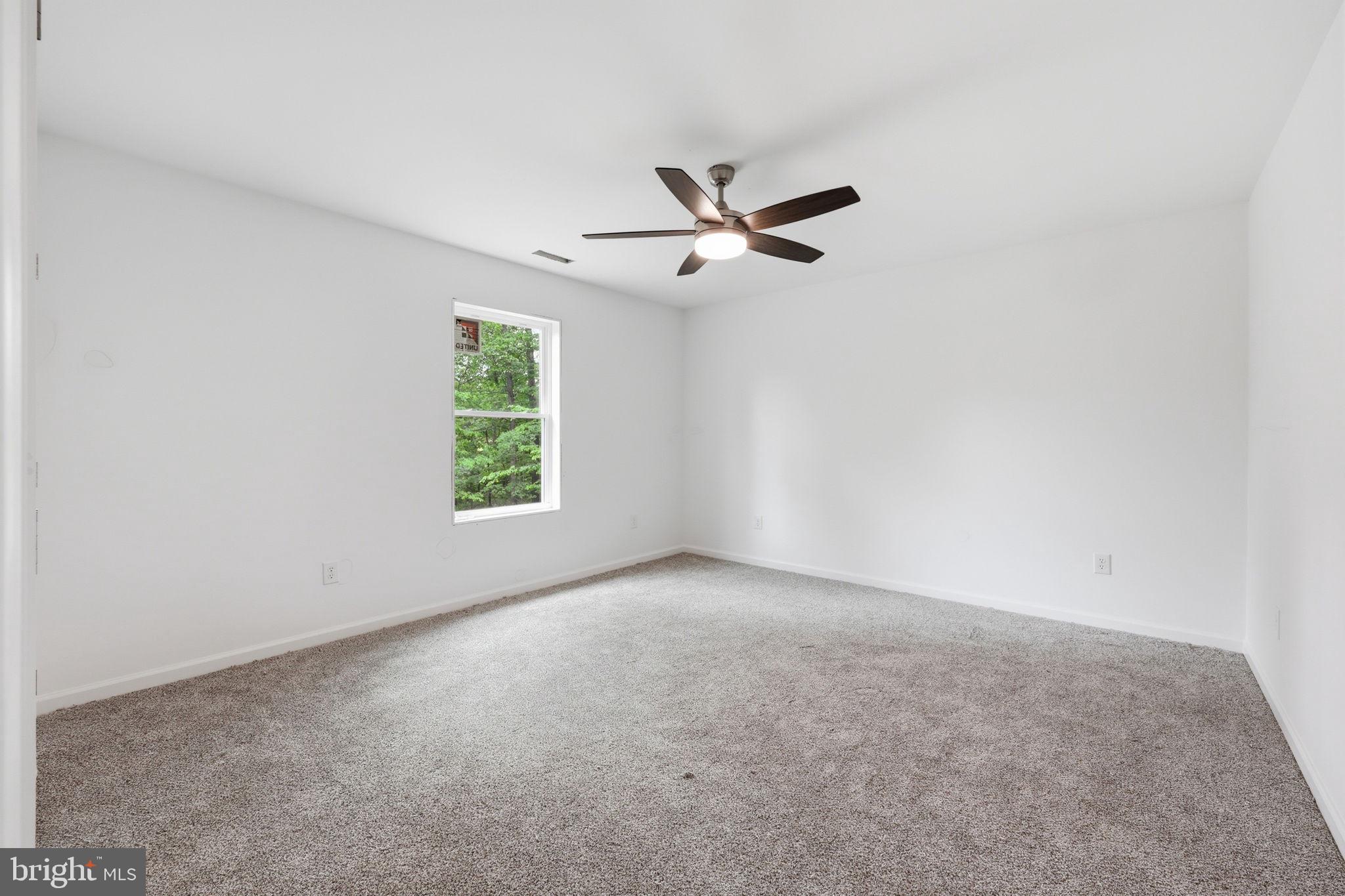 10339 Back Creek Valley Road Hedgesville, WV 25427 - Photo 30 of 48 a view of room with a ceiling fan and a window