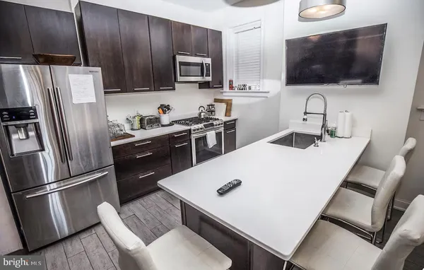a kitchen with sink cabinets and wooden floor