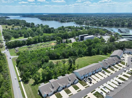 an aerial view of a house with a yard and lake view