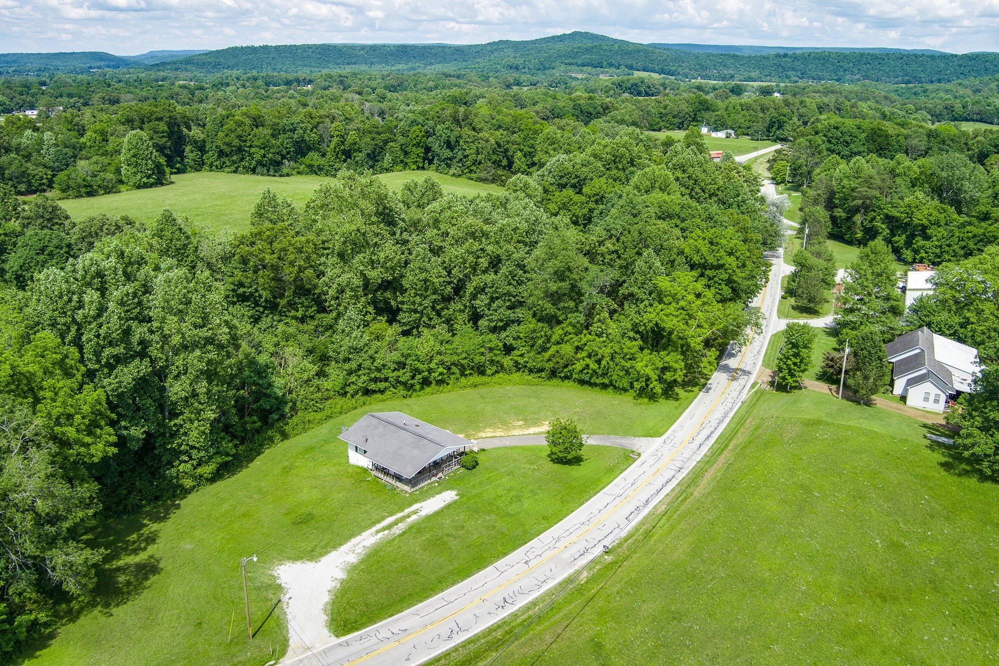 1121 East Gooseneck Road Doyle, TN 38559 - Photo 14 of 20 a view of a green yard with large trees