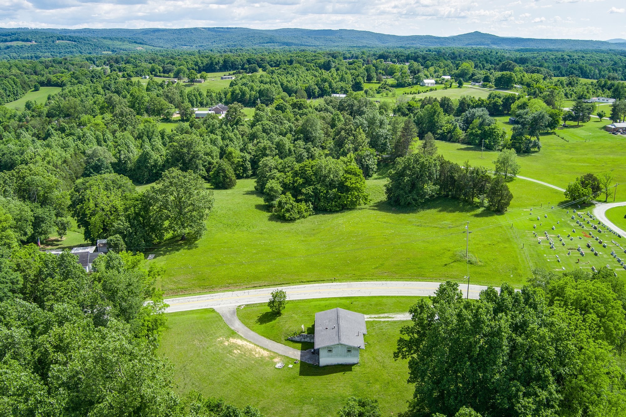 1121 East Gooseneck Road Doyle, TN 38559 - Photo 16 of 20 a view of a garden with a building in the background