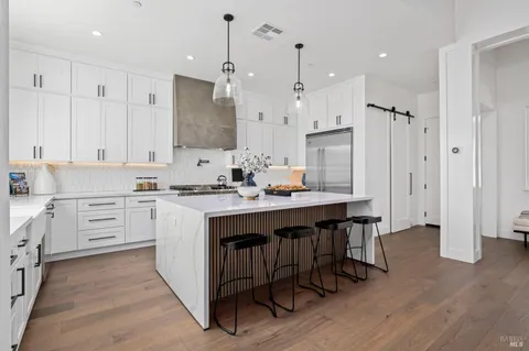 a kitchen with a sink stove and cabinets