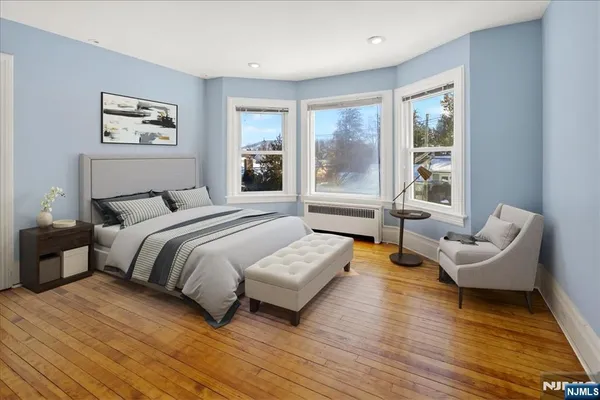 a spacious bedroom with a bed and a large window