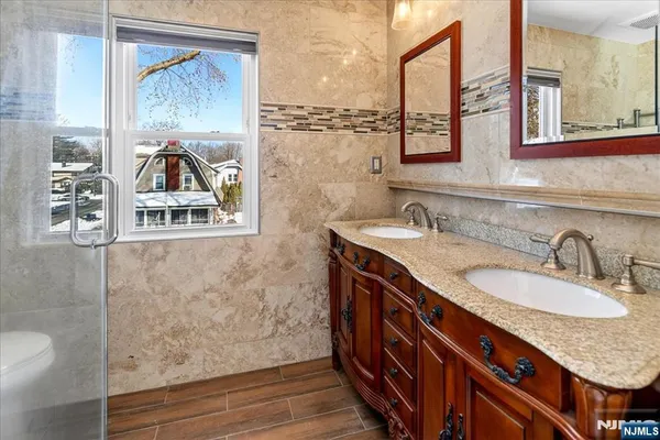 a bathroom with a granite countertop sink mirror and vanity