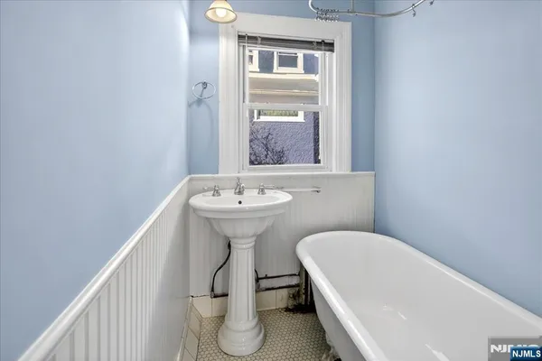 a bathroom with a sink a toilet and bathtub