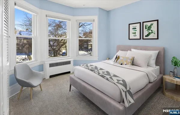 a bedroom with a bed and a chair