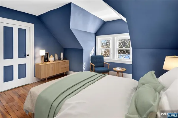 a bedroom with a bed a lamp and a large window