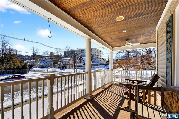 a view of a porch with furniture and wooden deck