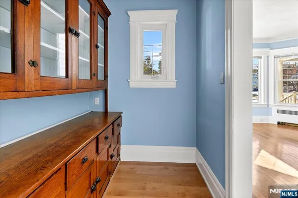 a view of an entryway with wooden floor and door