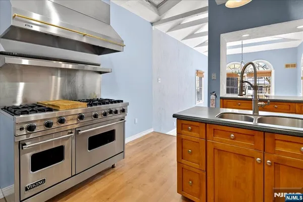 a kitchen with stainless steel appliances granite countertop a stove and a sink