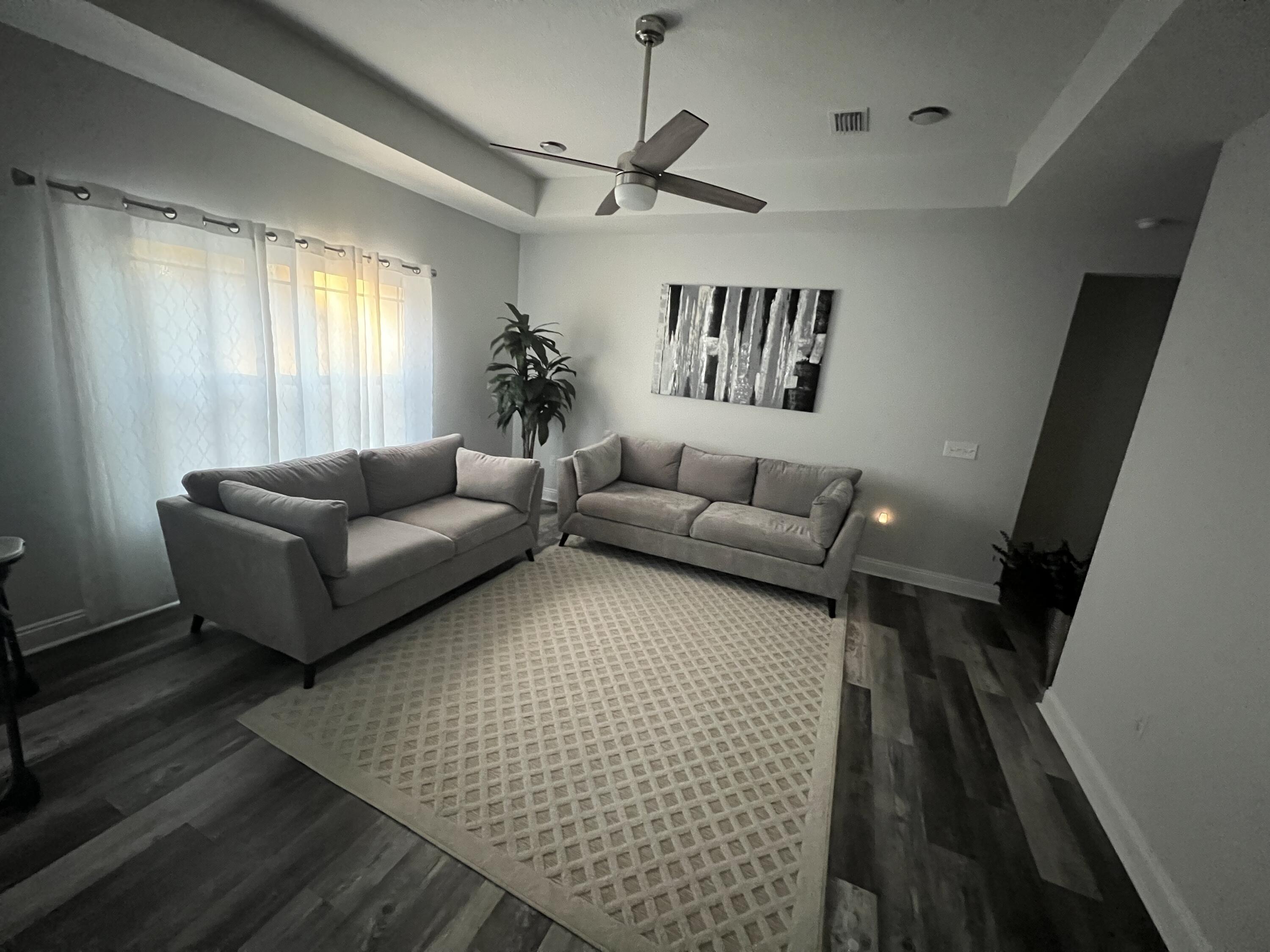5791 Kellie Drive Crestview, FL 32539 - Photo 5 of 8 a living room with furniture and a large window