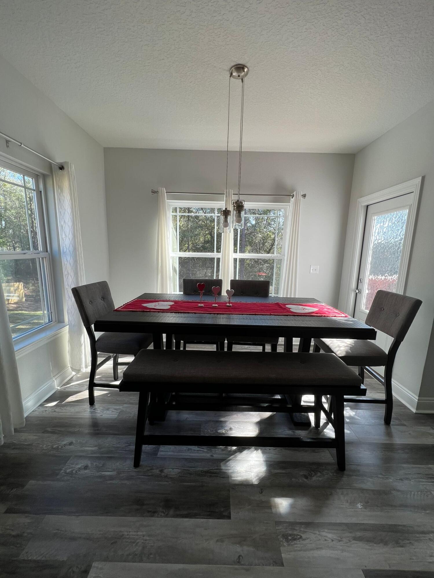 5791 Kellie Drive Crestview, FL 32539 - Photo 6 of 8 a room with a table chairs and a table