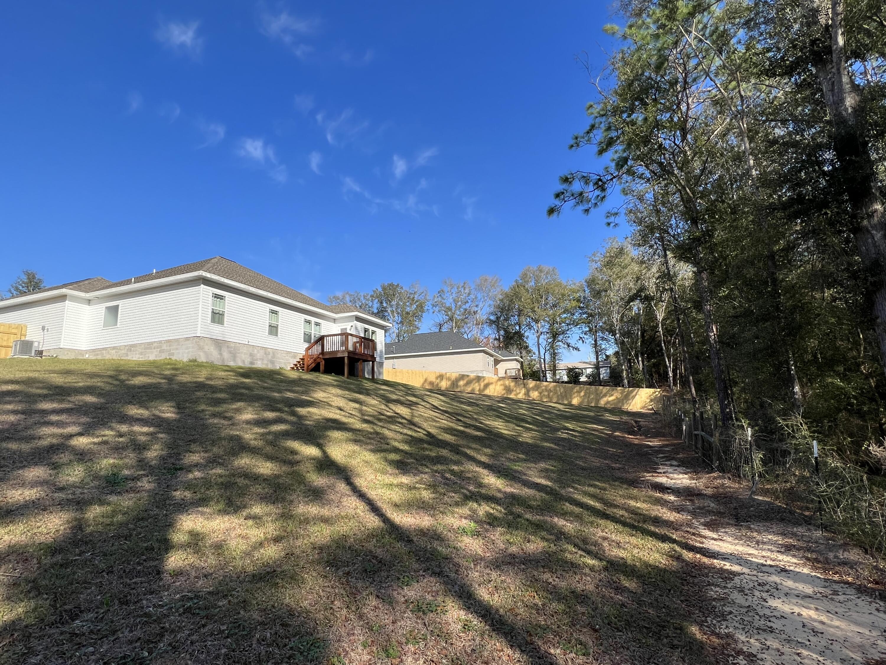 5791 Kellie Drive Crestview, FL 32539 - Photo 8 of 8 a tall building with trees in the background