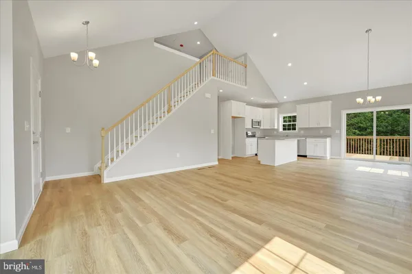 a view of empty room with wooden floor and windows
