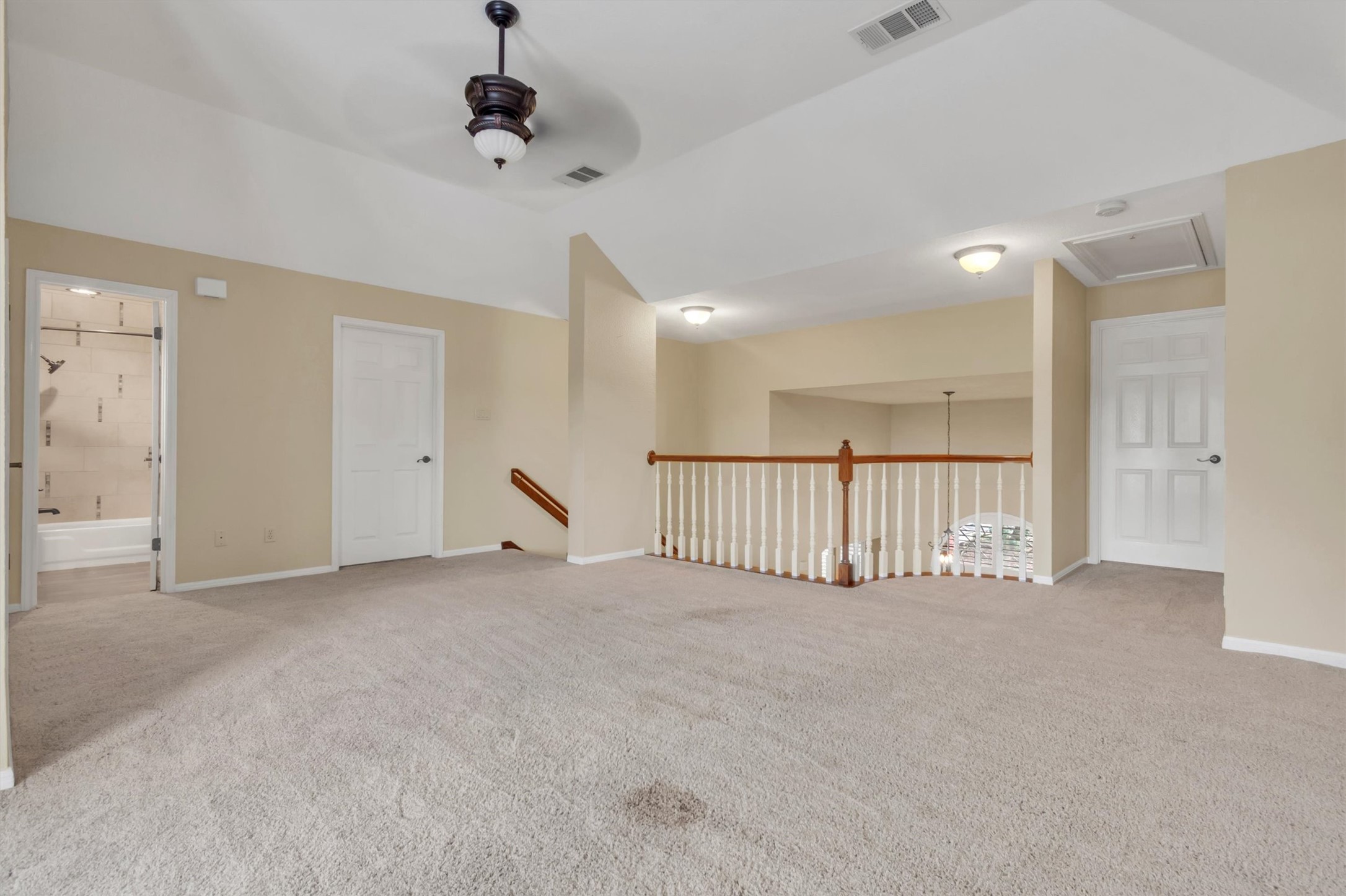 6008 Tributary Ridge Court Austin, TX 78759 - Photo 19 of 36 A spacious, carpeted loft area offers versatile living space and a view of the lower level.