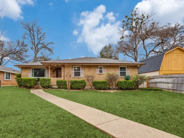 a view of empty room with wooden floor and fireplace