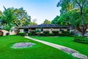 a front view of a house with a yard table and chairs