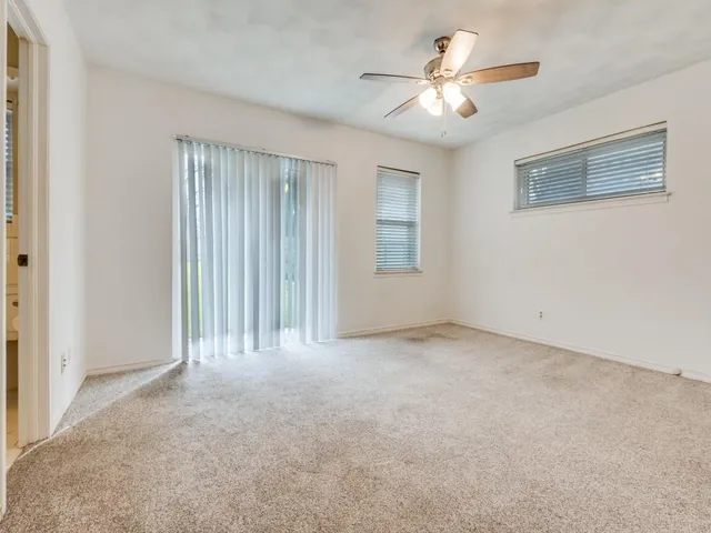a view of a livingroom with a ceiling fan and window