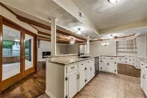 a kitchen with granite countertop a sink and cabinets