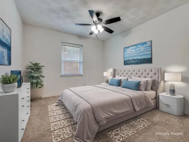 a bedroom with bed and a potted plant