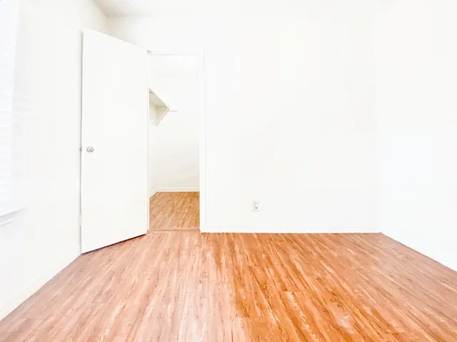 a view of a room with wooden floor