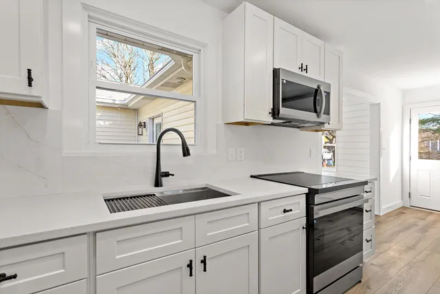 a room with wooden floor and white walls