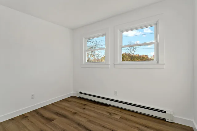 a bathroom with double vanity sink a mirror and a toilet