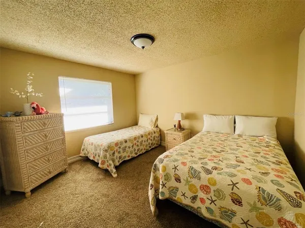 a bedroom with two beds and lamp
