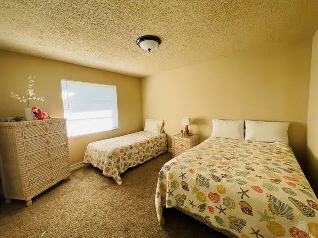 a bedroom with two beds and lamp