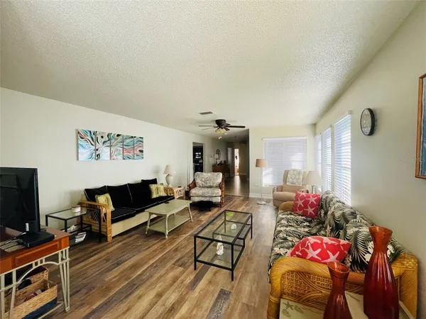 a living room with furniture or wooden floor and a flat screen tv