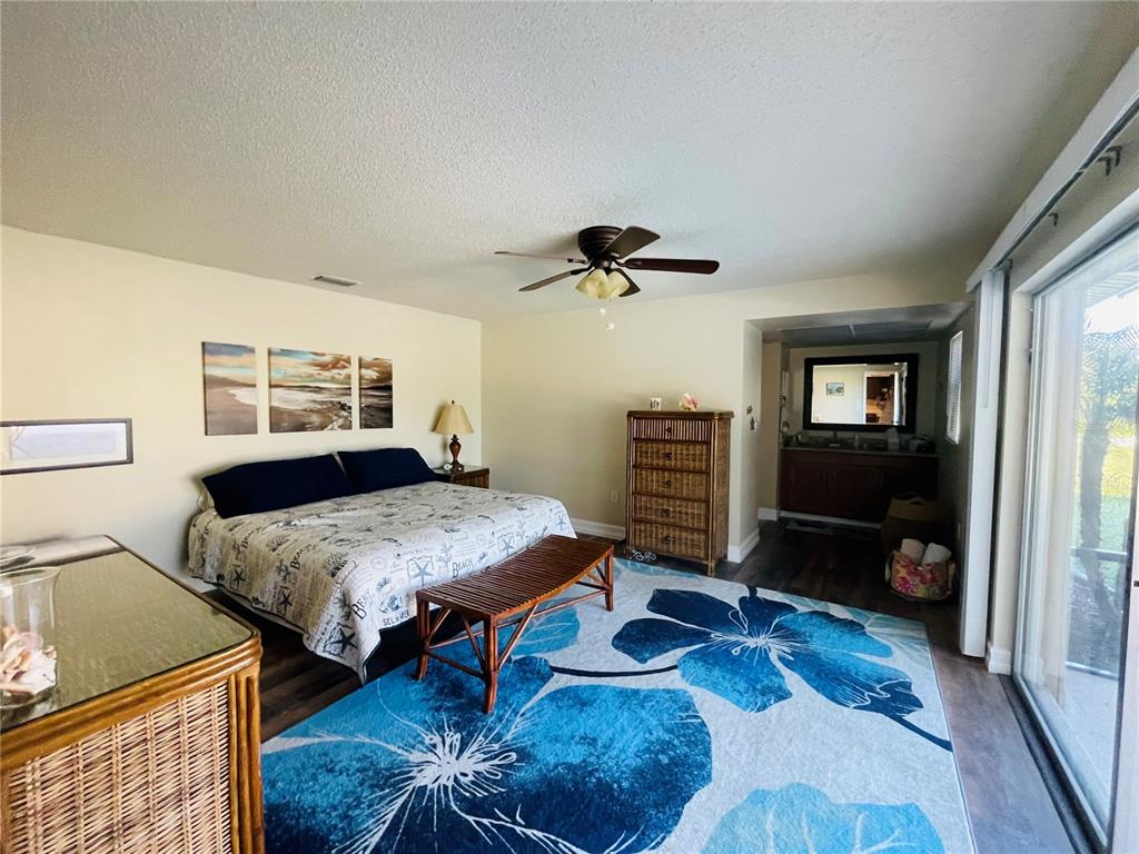 3405 Indiana Road Rotonda West, FL 33947 - Photo 8 of 17 a bedroom with furniture and a wooden floor