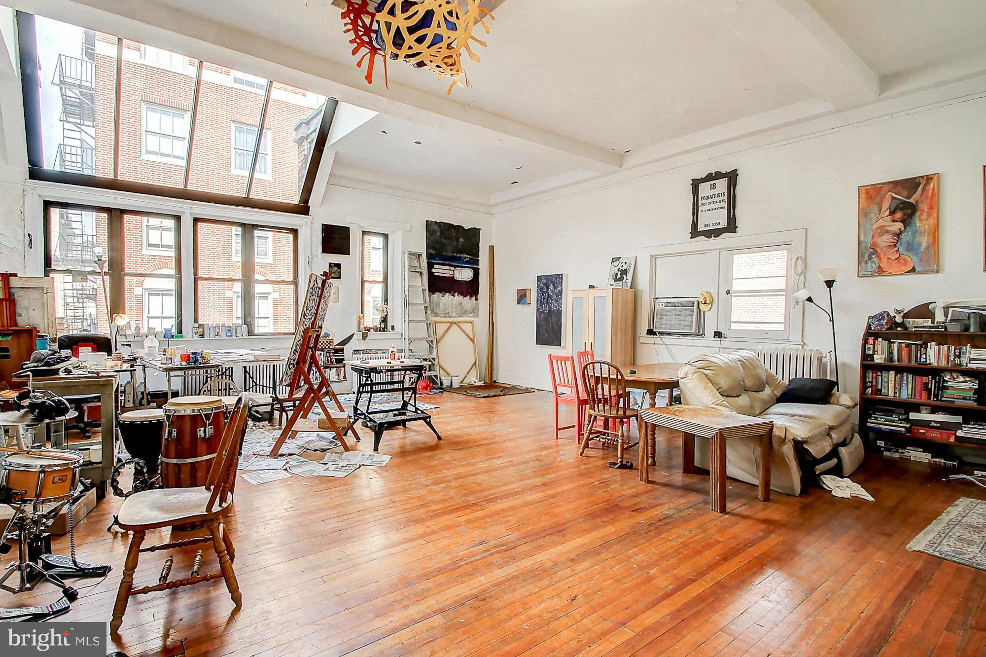 18 West Franklin Street Baltimore, MD 21201 - Photo 12 of 30 a living room with furniture a rug wooden floor and a large window